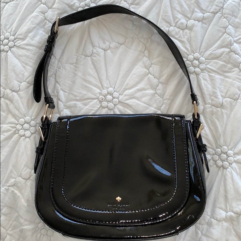A black patent leather Kate Spade purse.